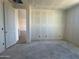 Unfinished bedroom featuring an open door, bare drywall, and concrete floor awaiting customization at 15792 W Beryl Ave, Waddell, AZ 85355