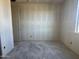 Empty bedroom under construction featuring unfinished concrete floors, a door, and a window at 15792 W Beryl Ave, Waddell, AZ 85355