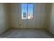 A bedroom under construction featuring unfinished concrete floors and natural light from a window at 15792 W Beryl Ave, Waddell, AZ 85355