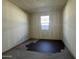 A bedroom under construction featuring unfinished concrete floors, a window, and natural light at 15792 W Beryl Ave, Waddell, AZ 85355