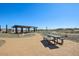 Comfortable picnic area with seating under a shaded ramada within the community at 15792 W Beryl Ave, Waddell, AZ 85355