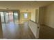 An open-concept living area with sliding glass doors and wood-look tile flooring, ready for finishing touches at 15792 W Beryl Ave, Waddell, AZ 85355