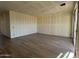 Unfinished living room area with tile flooring, drywall, and sliding glass door leading to the patio at 15792 W Beryl Ave, Waddell, AZ 85355