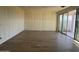 An open-concept living area with sliding glass doors and wood-look tile flooring, ready for finishing touches at 15792 W Beryl Ave, Waddell, AZ 85355