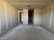 Unfinished Living Room featuring modern structural elements, ready for customization at 15792 W Beryl Ave, Waddell, AZ 85355