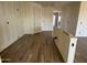 An open-concept room with wood-look tile flooring, ready for customization, offering a versatile space at 15792 W Beryl Ave, Waddell, AZ 85355