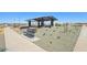 Park features a covered picnic area with tables and benches, surrounded by decorative rock and landscaping at 15792 W Beryl Ave, Waddell, AZ 85355