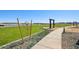 Park area featuring green grass, walking path, decorative rock landscaping, and benches at 15792 W Beryl Ave, Waddell, AZ 85355