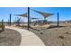 Community park featuring playground and picnic area with walking paths and desert landscaping at 15792 W Beryl Ave, Waddell, AZ 85355