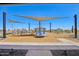 Community playground with shade canopies, and various play structures for recreation at 15792 W Beryl Ave, Waddell, AZ 85355