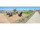 Outdoor seating area featuring comfortable Adirondack chairs and a nearby game of cornhole at 15792 W Beryl Ave, Waddell, AZ 85355
