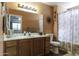 The bathroom features a vanity with a large mirror, and a shower with a curtain at 1623 E Krystal St, Casa Grande, AZ 85122