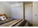 Modest bedroom featuring a bed, closet, and a door at 1623 E Krystal St, Casa Grande, AZ 85122