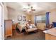 Cozy bedroom with neutral walls, a ceiling fan, and a window with blue curtains at 1623 E Krystal St, Casa Grande, AZ 85122