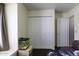 Modest bedroom featuring a bed, closet, door, and a fish tank at 1623 E Krystal St, Casa Grande, AZ 85122