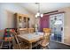 Warm dining room with wooden table and chairs, hutch, decorative chandelier, and sliding glass door at 1623 E Krystal St, Casa Grande, AZ 85122