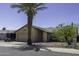 Cozy single-story home with two-car garage, desert landscaping and a large palm tree in the front yard at 1623 E Krystal St, Casa Grande, AZ 85122