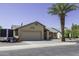 Inviting single-story home with desert landscaping, a two-car garage and an RV trailer parked on the side at 1623 E Krystal St, Casa Grande, AZ 85122