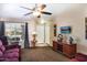Welcoming living room with large window, entertainment center, ceiling fan, and neutral décor at 1623 E Krystal St, Casa Grande, AZ 85122