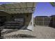 Backyard covered patio with a luxurious hot tub and desert landscaping, ideal for tranquil outdoor living at 1623 E Krystal St, Casa Grande, AZ 85122