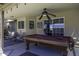 Charming covered patio featuring a pool table and comfortable seating, perfect for outdoor entertainment at 1623 E Krystal St, Casa Grande, AZ 85122