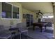 Spacious covered patio featuring a pool table, ceiling fan, comfortable seating, and a hot tub at 1623 E Krystal St, Casa Grande, AZ 85122