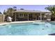Stunning backyard pool adjacent to covered patio and lush landscaping, a perfect oasis for relaxation at 1623 E Krystal St, Casa Grande, AZ 85122