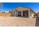 An inviting backyard features gravel landscaping, a covered patio, and ample space for outdoor activities at 19834 N Tammy St, Maricopa, AZ 85138