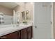 Bathroom features a single sink vanity with dark wood cabinets and white countertop, with tile flooring at 19834 N Tammy St, Maricopa, AZ 85138