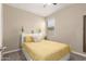 Cozy bedroom with neutral walls, carpet flooring, a ceiling fan, and simple furnishings with a warm, inviting feel at 19834 N Tammy St, Maricopa, AZ 85138