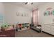 bedroom with playful decor, built-in shelving, a ceiling fan, and a gray sofa at 19834 N Tammy St, Maricopa, AZ 85138