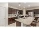 Modern kitchen featuring granite countertops, stainless steel appliances, and a large island at 19834 N Tammy St, Maricopa, AZ 85138
