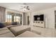 Bright living room featuring a sectional sofa, ceiling fan, and sliding door to the backyard at 19834 N Tammy St, Maricopa, AZ 85138