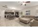 Open-concept kitchen, dining, and living area with tile flooring and stainless steel appliances at 19834 N Tammy St, Maricopa, AZ 85138