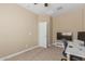 Office with tan walls, carpet flooring, a ceiling fan, a computer, and bright natural light, with a door open at 19834 N Tammy St, Maricopa, AZ 85138