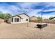 Large backyard with a patio, desert landscaping and string lights, perfect for entertaining at 2030 S 86Th Dr, Tolleson, AZ 85353