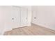Minimalist bedroom with closet, white walls, and wood-look flooring, offering a blank canvas for personalization at 2030 S 86Th Dr, Tolleson, AZ 85353