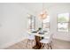Bright dining area with modern table and chairs, illuminated by a stylish pendant light at 2030 S 86Th Dr, Tolleson, AZ 85353