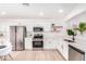 Bright kitchen with stainless steel appliances, white cabinets, and quartz countertops offers a modern design at 2030 S 86Th Dr, Tolleson, AZ 85353
