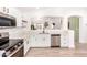 Well-lit kitchen boasts stainless steel appliances, quartz countertops, and an open view to the living area at 2030 S 86Th Dr, Tolleson, AZ 85353