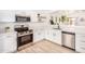 Contemporary kitchen featuring stainless steel appliances, white cabinets, and open layout at 2030 S 86Th Dr, Tolleson, AZ 85353