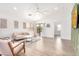 Bright living room with modern furniture, neutral decor, and stylish accent wall at 2030 S 86Th Dr, Tolleson, AZ 85353