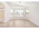 Bright living room featuring neutral walls, wood-look floors, and an abundance of natural light through large windows at 2030 S 86Th Dr, Tolleson, AZ 85353