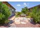 Beautiful backyard landscaping with stone path and a wooden bench with blue cushions at 21150 N Evergreen Dr, Maricopa, AZ 85138