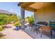 Cozy covered patio with comfortable seating and views of the lush backyard at 21150 N Evergreen Dr, Maricopa, AZ 85138