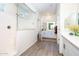 Bright bathroom with white cabinets, double sinks, and a glass-enclosed shower at 21150 N Evergreen Dr, Maricopa, AZ 85138