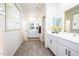 The bathroom has double sinks, white cabinets, and a separate glass-enclosed shower at 21150 N Evergreen Dr, Maricopa, AZ 85138