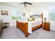 Cozy bedroom with a comfortable bed, soft carpet, and ample natural light at 21150 N Evergreen Dr, Maricopa, AZ 85138