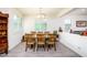 Inviting dining area with a modern chandelier and plantation shutters at 21150 N Evergreen Dr, Maricopa, AZ 85138