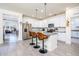 Bright kitchen features an island with granite counters, stainless steel appliances, and modern pendant lighting at 21150 N Evergreen Dr, Maricopa, AZ 85138